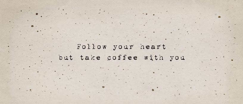Follow your heart, but take coffee with you. Funny caffeine addiction text art illustration, minimalist typewriter font style written on old paper texture. Creative banner, trendy vintage style design