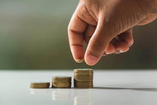 Hand drop a coin with money coin stack growing for business. financial and accounting concept.