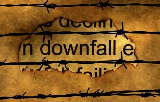 Downfall text on paper hole against barbwire