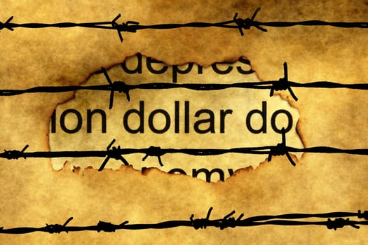 Dollar text on paper hole against barbwire