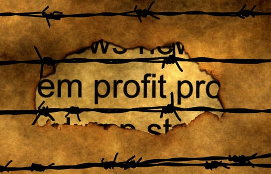 Profit text on paper hole against barbwire