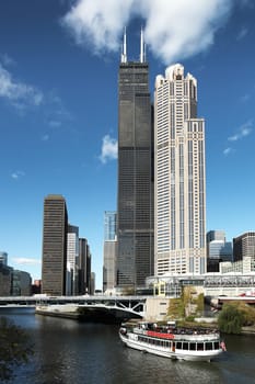 CHICAGO, ILLINOIS/USA-OCTOBER 16 2016: Chicago River and tall buildings with Tourist Boat and blue sky on October 16 2016, Chicago, Illinois