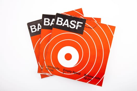 WETZLAR, GERMANY 2020-05-13 Box with BASF 7" Empty Spools over bright Background. In 1934, BASF presented the world's first tapes."