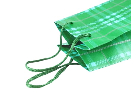 Closeup of green present bag over white