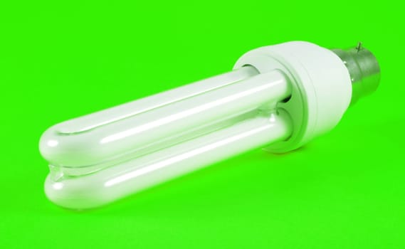 Economic light bulb over green background
