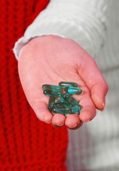 female hand with medicine pills on white