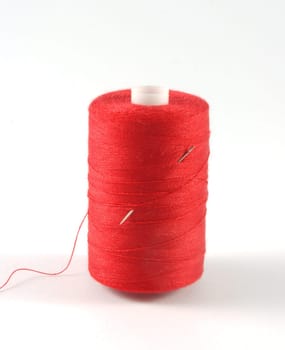 red threads with needle isolated on white