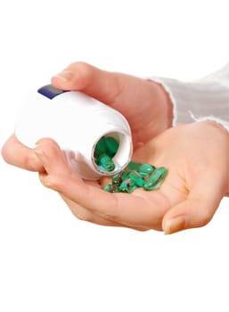 female hand with medicine pills on white
