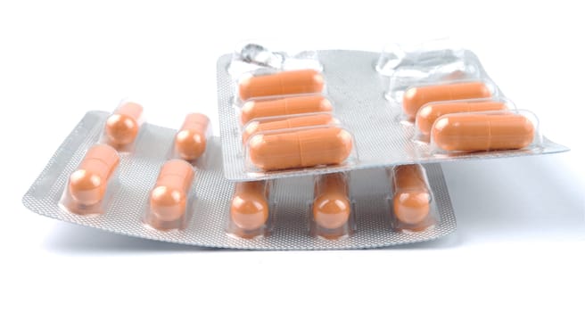 yellow medicine pills over white