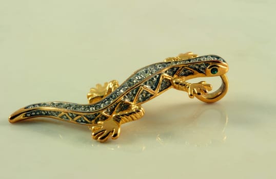 jewelry in shape of lizard with stones on marble surface
