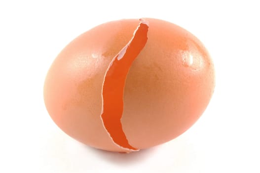 broken egg closeup over white background