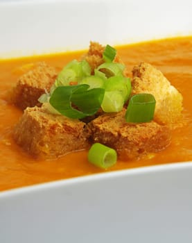 pumpkin soup with crackers and onion