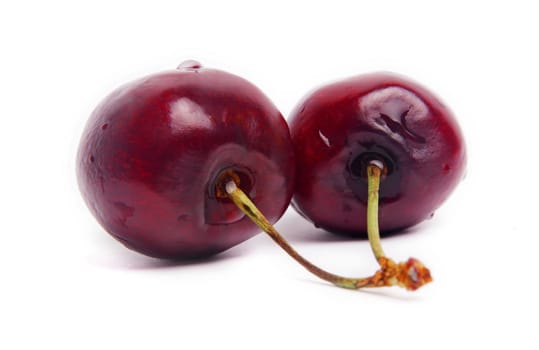 two fresh cherries isolated on white