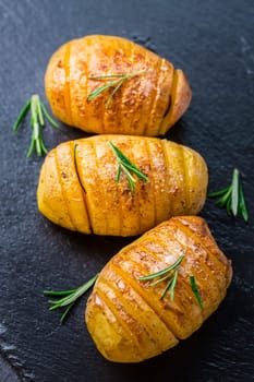 Hasselback potatoes. Backed potatoes from Sweden with garlic and herbs grilled in the oven.