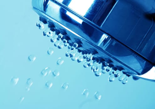 shower head closeup with water drops