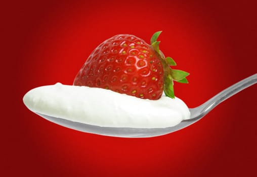 strawberry with cream on the spoon over red