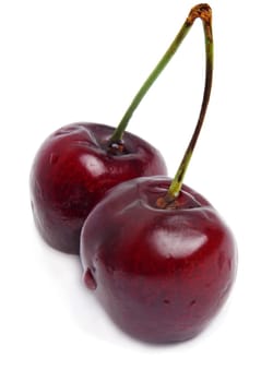 two fresh cherries isolated on white