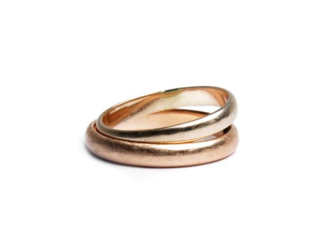 two worn golden rings on white