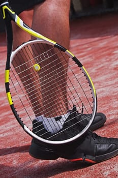 tennis player legs with racket