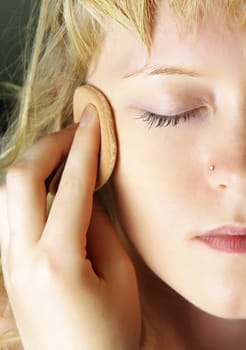 closeup of woman doing facial treatments