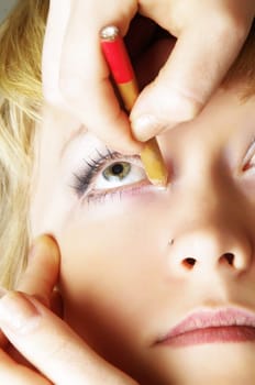 closeup of woman doing eyes treatments