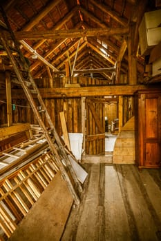 Interior of old wooden shed with scrap wood with sunrays. Old barn.