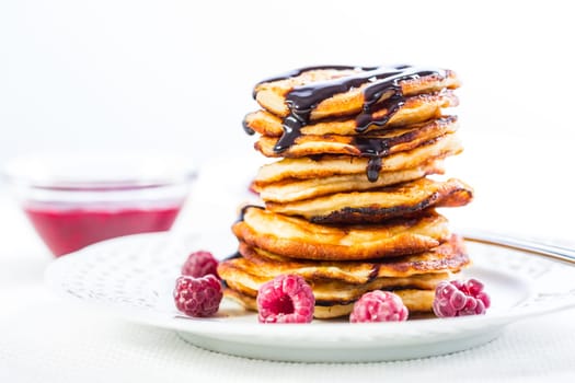 Delicious cottage cheese pancakes with fresh raspberry and chocolate sirup. Curd fritters.