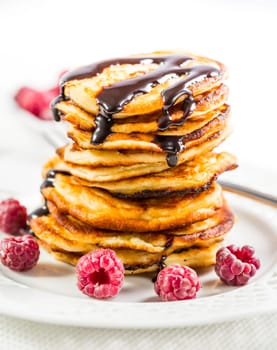 Delicious cottage cheese pancakes with fresh raspberry and chocolate sirup. Curd fritters.