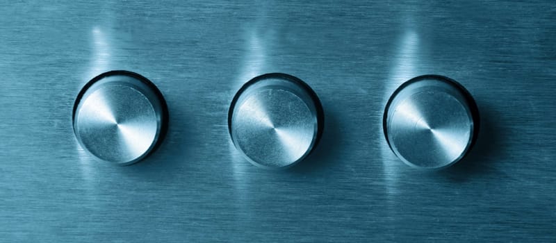 closeup of three electronic round switches