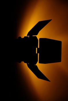 studio flash silhoutte with orange light on wall