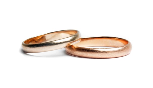 two worn golden rings on white