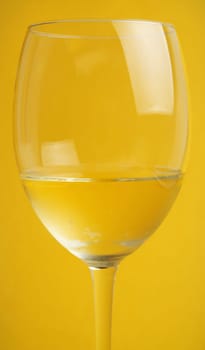 glass of wine on the yellow background