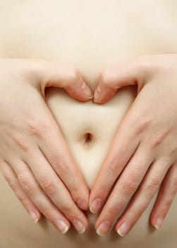 female hands on bare belly