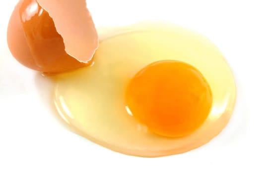 broken egg closeup over white background