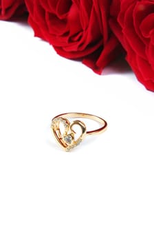wedding ring with rose over white surface