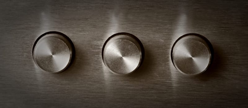 closeup of three electronic round switches