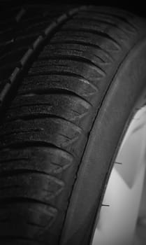 dark used tyre closeup. shallow dof