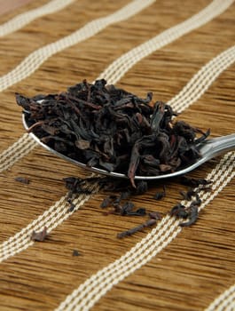 tea leaves on spoon closeup.shallow DOF
