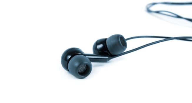 earphones closeup over the white surface.blue tone