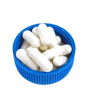white medicine pills on the blue cover