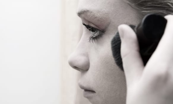 woman applying make up. shallow DOF