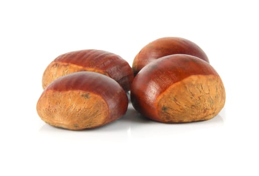 delicious chestnuts closeup over white
