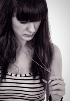 toned picture of woman looking on the neck watch