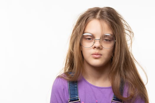 Portrait of a funny girl with her long hair and half-closed eyes