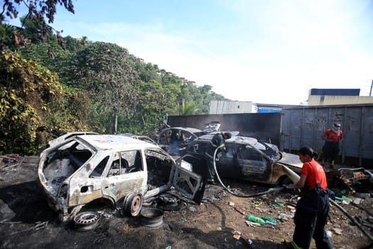 salvador, bahia / brazil - january 25, 2016: members of the fire brigade are seen during the aftermath in a vehicle fire in the Lobato neighborhood in the city of Salvador..
