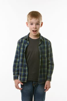 Astonished ten year old boy with open mouth on white background