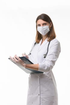 Girl doctor makes notes in the medical history on a tablet