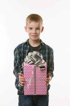 A boy holds a birthday gift in his hands