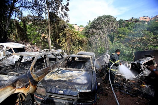 salvador, bahia / brazil - january 25, 2016: members of the fire brigade are seen during the aftermath in a vehicle fire in the Lobato neighborhood in the city of Salvador..
