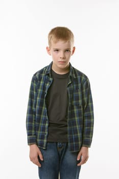 Portrait of an annoyed boy of ten years on a white background